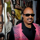 Stevie Wonder stands in front of a mural of Apollo legends. (Getty)